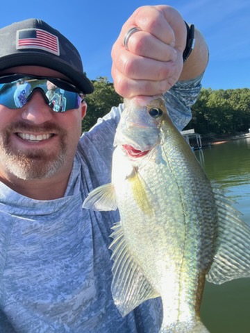 Angler holding up a crappie on Lake Lanier